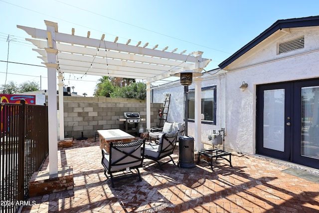 view of patio / terrace with area for grilling, a pergola, and french doors