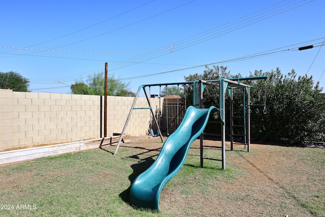 view of playground with a lawn