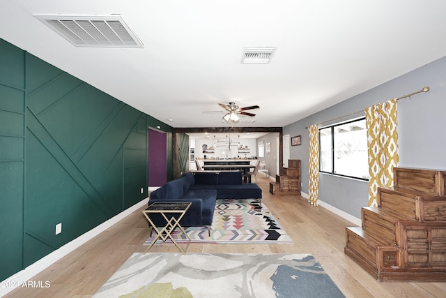 living room with ceiling fan and light hardwood / wood-style floors