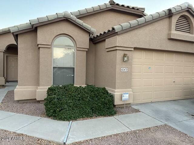 view of side of property with a garage