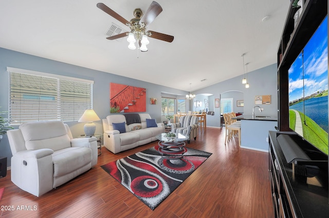 living room featuring sink, lofted ceiling, dark hardwood / wood-style floors, and ceiling fan with notable chandelier