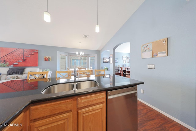 kitchen featuring pendant lighting, sink, lofted ceiling, dishwasher, and dark hardwood / wood-style flooring