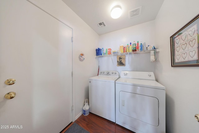 laundry area with dark hardwood / wood-style floors and washer and dryer