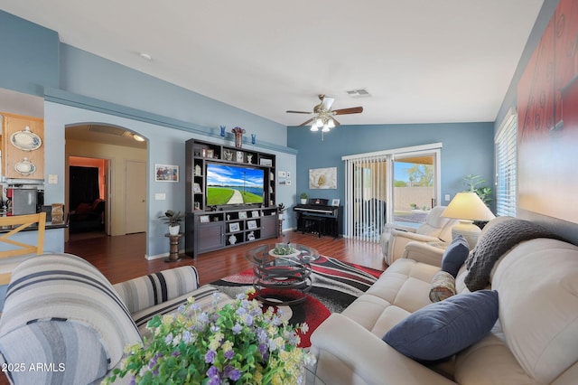 living room with ceiling fan, lofted ceiling, and dark hardwood / wood-style flooring