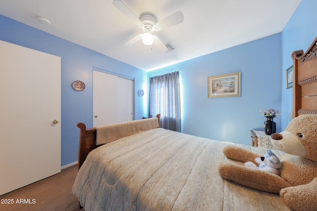 carpeted bedroom featuring ceiling fan and a closet