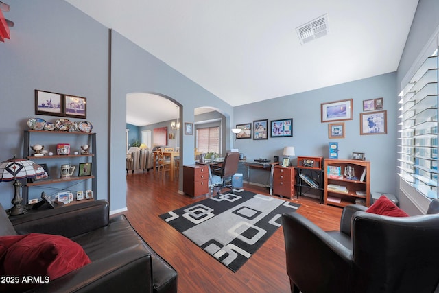 home office featuring dark wood-type flooring and high vaulted ceiling