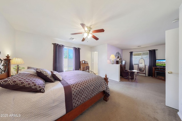 carpeted bedroom with multiple windows and ceiling fan