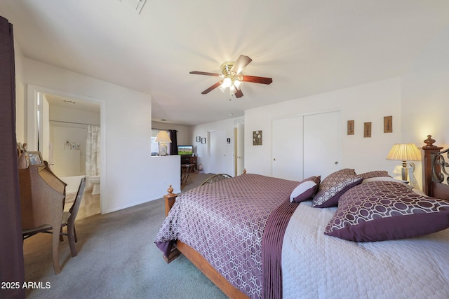 carpeted bedroom with ensuite bathroom, ceiling fan, and a closet