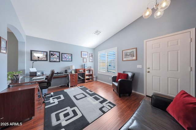 office featuring lofted ceiling, dark wood-type flooring, and a notable chandelier