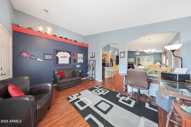 office area with wood-type flooring and a notable chandelier