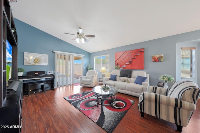 living room with dark wood-type flooring, ceiling fan, a healthy amount of sunlight, and vaulted ceiling