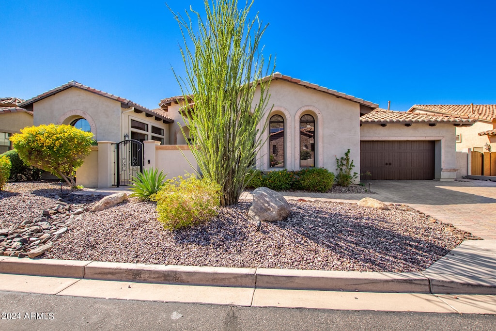 mediterranean / spanish-style home featuring a garage