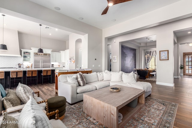 living room featuring dark hardwood / wood-style floors and ceiling fan