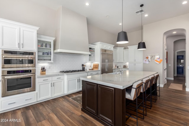 kitchen with white cabinets, stainless steel appliances, and dark wood-type flooring