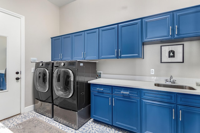 laundry room featuring cabinets, sink, washing machine and clothes dryer, and light tile patterned floors