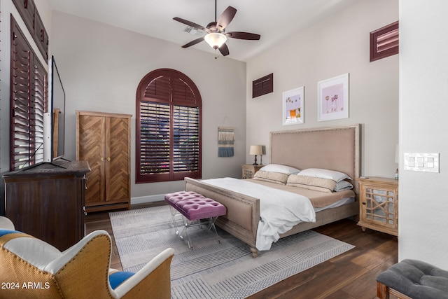 bedroom featuring dark wood-type flooring, multiple windows, and ceiling fan