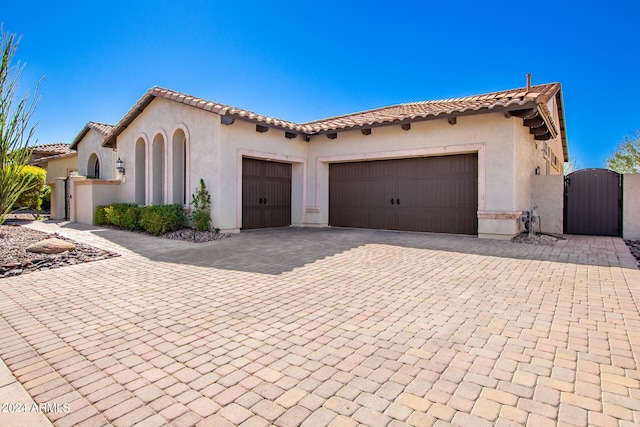 mediterranean / spanish house with a garage