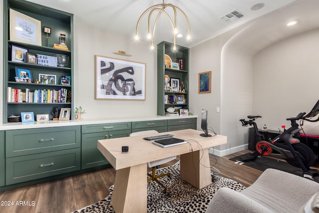 office featuring dark hardwood / wood-style floors, a chandelier, and built in shelves