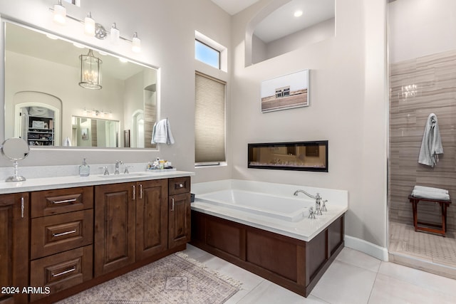 bathroom featuring vanity, a tub, and tile patterned flooring