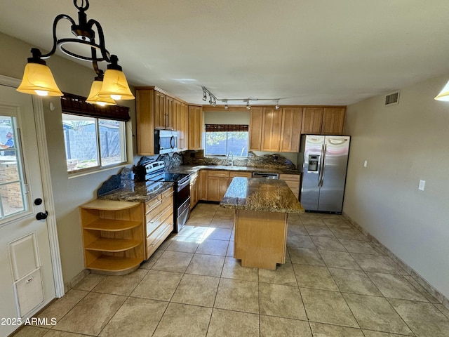 kitchen featuring open shelves, tasteful backsplash, a kitchen island, stainless steel appliances, and dark stone counters