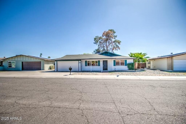 ranch-style house featuring concrete driveway