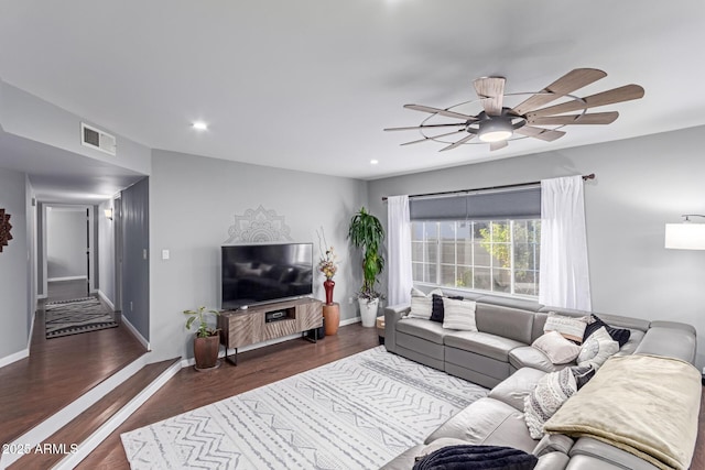 living area featuring recessed lighting, visible vents, baseboards, and wood finished floors