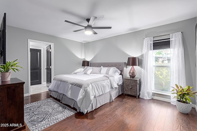 bedroom featuring ceiling fan, baseboards, and wood finished floors