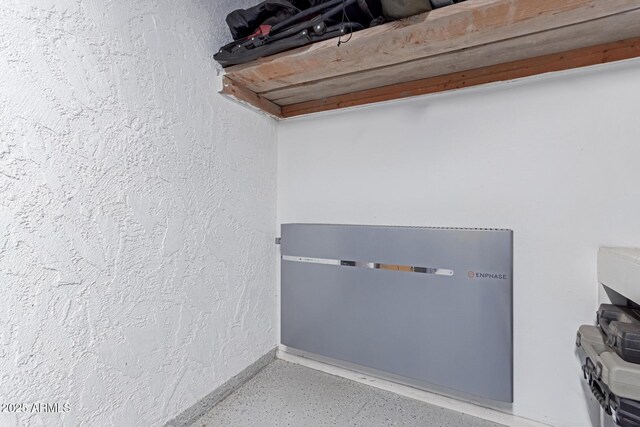 laundry area featuring a textured wall