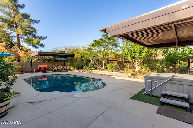 view of pool featuring a patio area, a fenced in pool, a hot tub, and a fenced backyard
