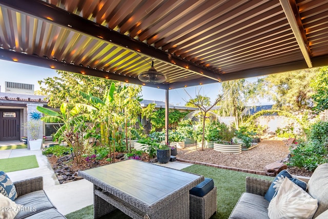 view of patio / terrace featuring a vegetable garden and fence