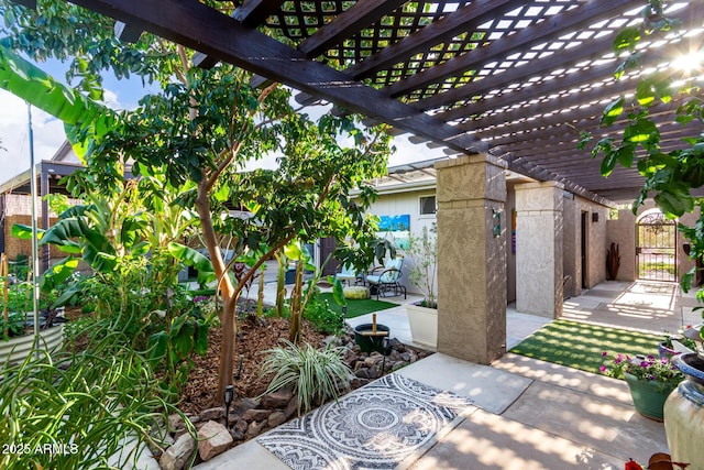 view of patio with a gate, fence, and a pergola