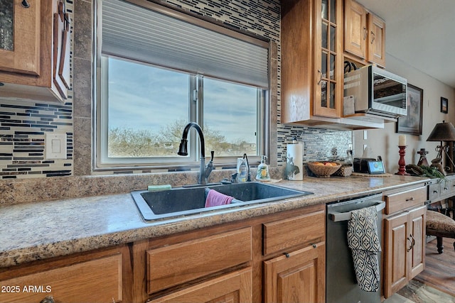 kitchen with sink, backsplash, and appliances with stainless steel finishes