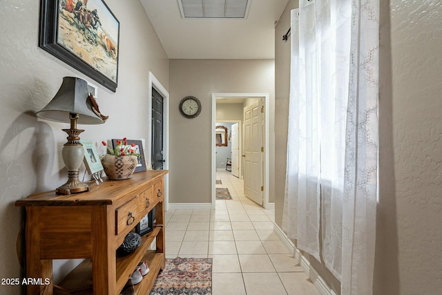 corridor featuring light tile patterned flooring