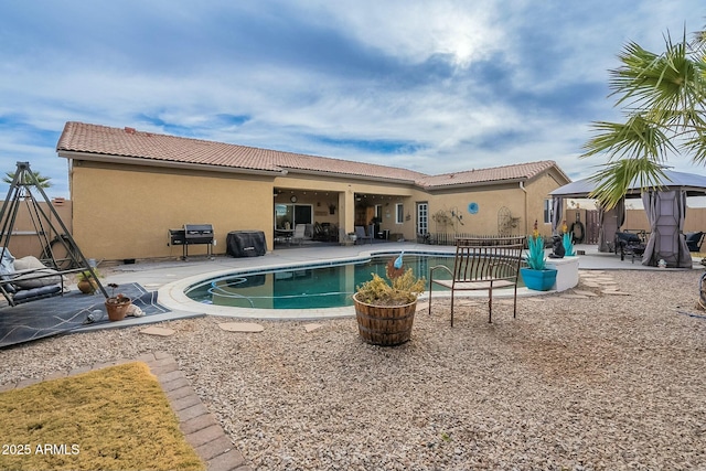 view of swimming pool featuring area for grilling, a gazebo, and a patio