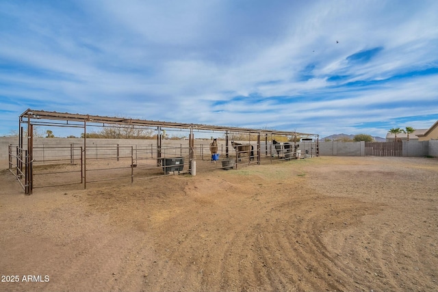 view of yard with an outdoor structure and a rural view