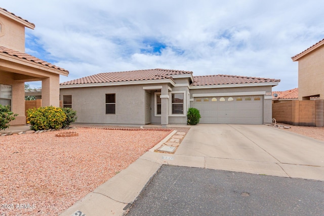 2326 E Spruce Dr, Chandler, AZ 85286 - mediterranean / spanish-style house with an attached garage, a tile roof, concrete driveway, and stucco siding