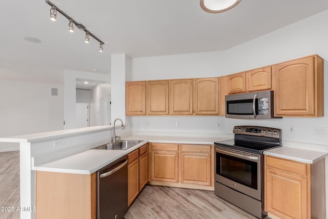 2326 E Spruce Dr, Chandler, AZ 85286 - kitchen featuring appliances with stainless steel finishes, a sink, light brown cabinets, a peninsula, and light wood-style floors