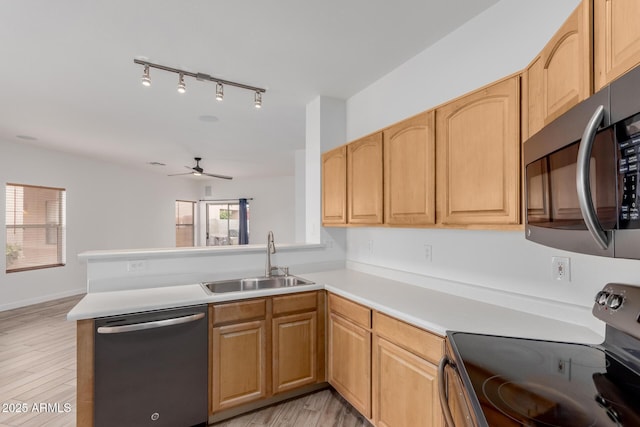 2326 E Spruce Dr, Chandler, AZ 85286 - kitchen featuring stainless steel appliances, a sink, a peninsula, a ceiling fan, and light countertops
