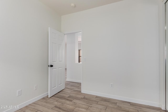 2326 E Spruce Dr, Chandler, AZ 85286 - empty room with light wood finished floors, baseboards, and a smoke detector