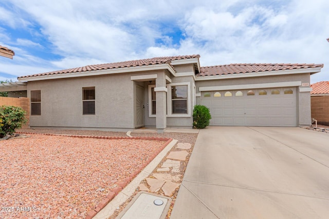 2326 E Spruce Dr, Chandler, AZ 85286 - mediterranean / spanish home featuring stucco siding, a garage, concrete driveway, and a tiled roof