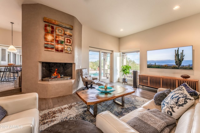 living room featuring a multi sided fireplace and hardwood / wood-style floors