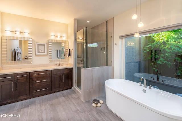 bathroom with vanity, wood-type flooring, and separate shower and tub