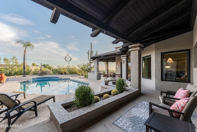 view of swimming pool featuring an outdoor living space and a patio area