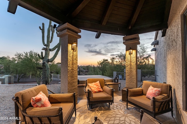 patio terrace at dusk featuring a gazebo and an outdoor living space