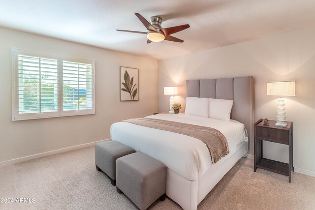 bedroom featuring light colored carpet and ceiling fan