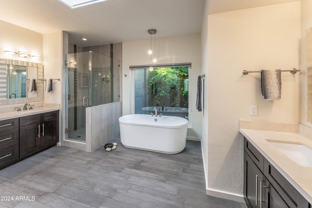 bathroom featuring vanity and independent shower and bath