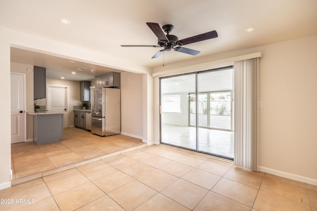 interior space with light tile patterned floors, recessed lighting, baseboards, and ceiling fan