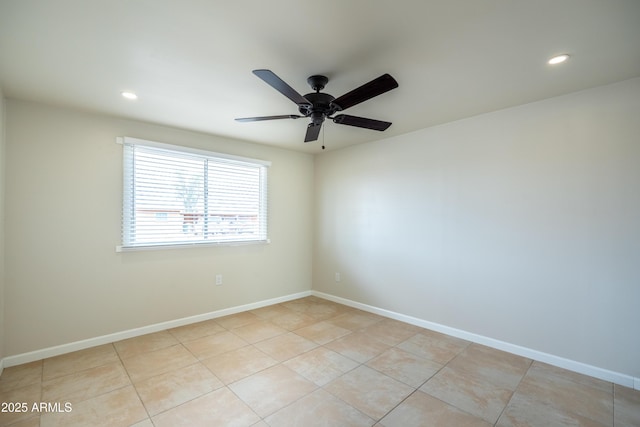 empty room with light tile patterned floors, baseboards, and ceiling fan