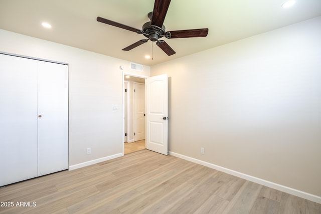 unfurnished bedroom with baseboards, visible vents, and light wood finished floors