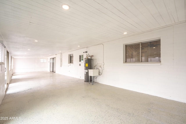 garage with recessed lighting and water heater